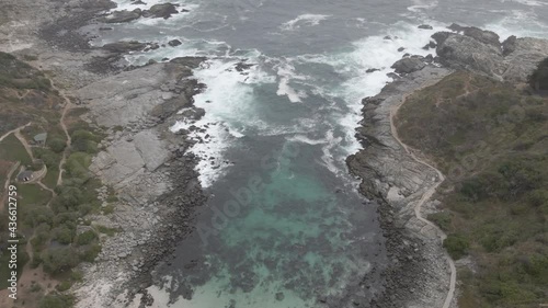 AERIAL - Rocky bay in Zapallar, Valparaiso, Chile, wide shot forward photo