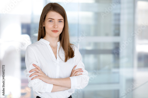 Beautiful female specialist with arms crossed standing in modern office and smiling charmingly. Working on design, data analysis, plan strategy. Business people concept Free Download Beautiful female specialist with arms crossed standing in modern office and smiling charmingly. Working on design, data analysis, plan strategy. Business people concept - GFXLoad