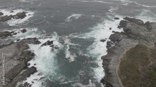 AERIAL - Rocky bay in Zapallar, Valparaiso, Chile, wide spinning shot photo
