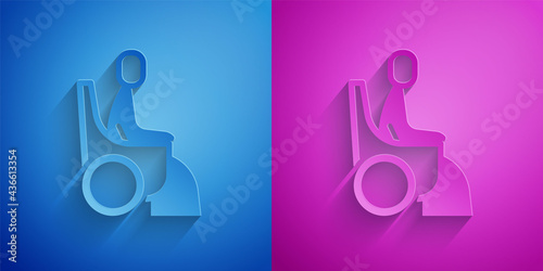 Paper cut Woman in wheelchair for disabled person icon isolated on blue and purple background. Paper art style. Vector