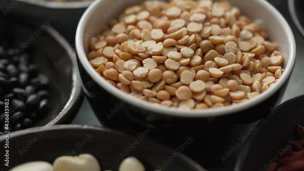Raw peas halfs seeds in ceramic bowl. Selective focus