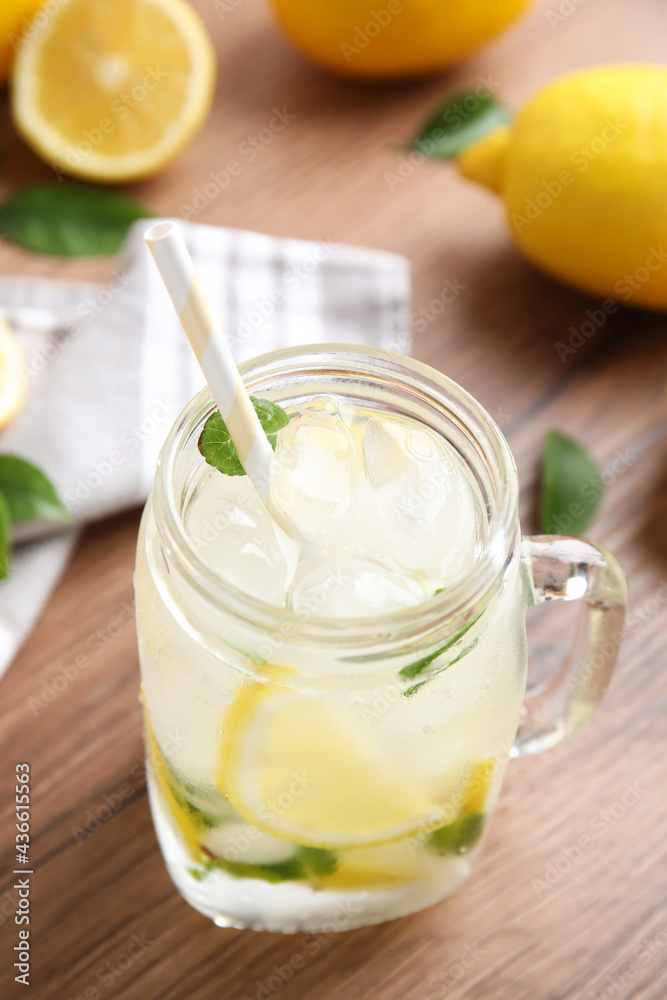 Mason jar of cold lemonade on wooden table Mason jar of cold lemonade on wooden table