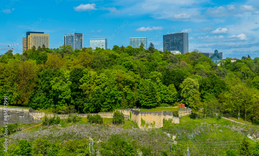Panoramic view of skyscrapers in Kirchberg, Luxembourg with green spaces and blue skies