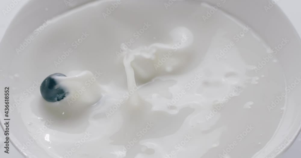 Blueberries slowly fall into yogurt. Morning healthy breakfast. 300fps Blueberries slowly fall into yogurt. Morning healthy breakfast. 300fps