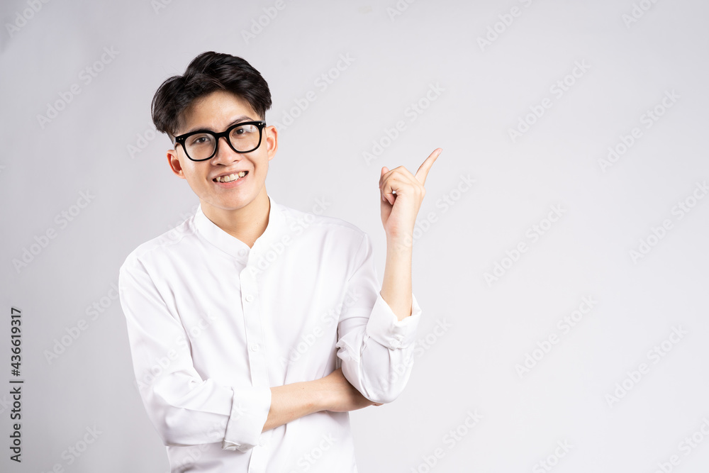 portrait of cheerful asian businessman man smiling and pointing, isolated on orange background
portrait of cheerful asian businessman man smiling and pointing, isolated on orange background