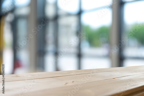 wood table on blur of cafe  coffee shop  bar  background - can used for display or montage your products