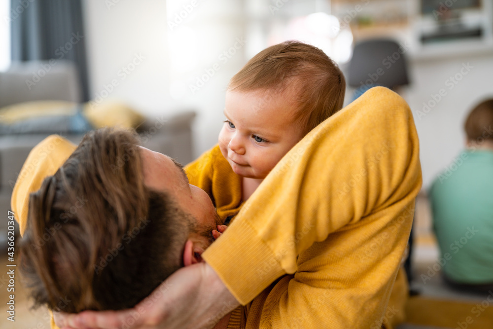 Happy young father playing with little daughter at home Happy young father playing with little daughter at home