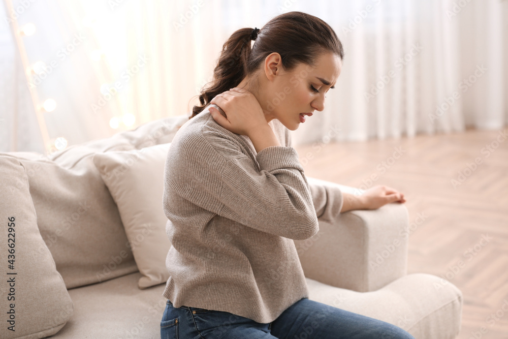 Woman suffering from neck pain at home. Bad posture problem Woman suffering from neck pain at home. Bad posture problem