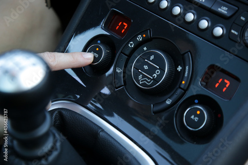 Hand ajusting the air conditioner in the car © triocean