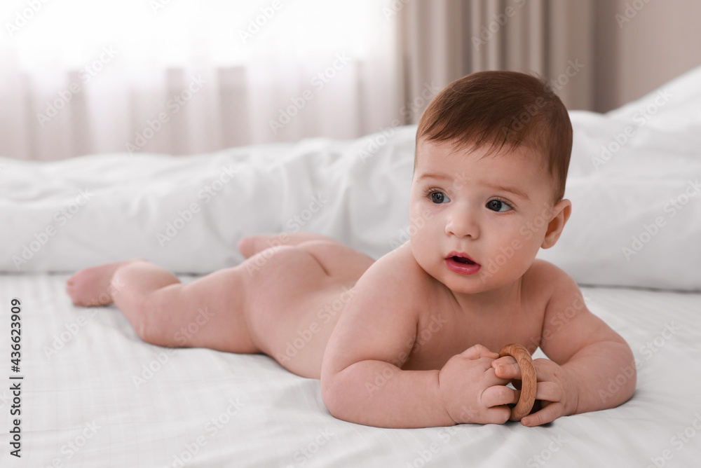 Cute little baby with toy on soft blanket indoors Cute little baby with toy on soft blanket indoors