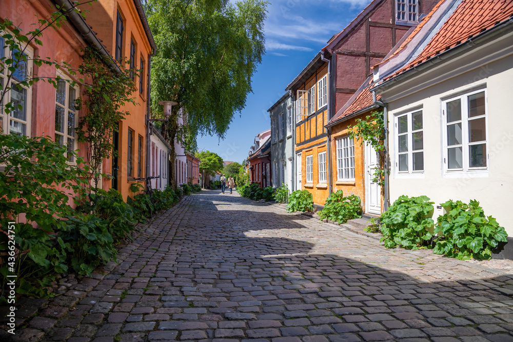 Aarhus, Denmark; May 30th, 2021 - Colourful old cottages on a quiet street in Aarhus, Denmark