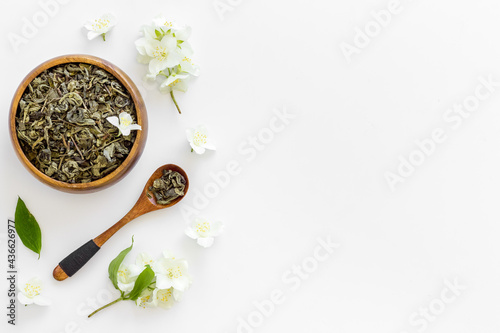 Jasmine flowers with dry tea in bowl. Top view