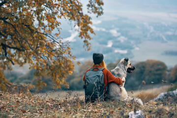 woman hiker next to dog friendship nature mountains travel