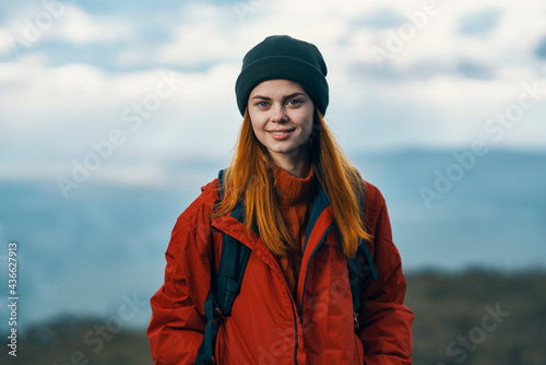 portrait of a traveler in the mountains in nature rock landscape clouds sky model