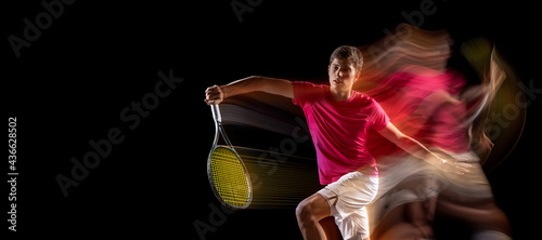 One man, male tennis player training isolated in mixed neon light on dark background. Concept of sport, team competition. © master1305