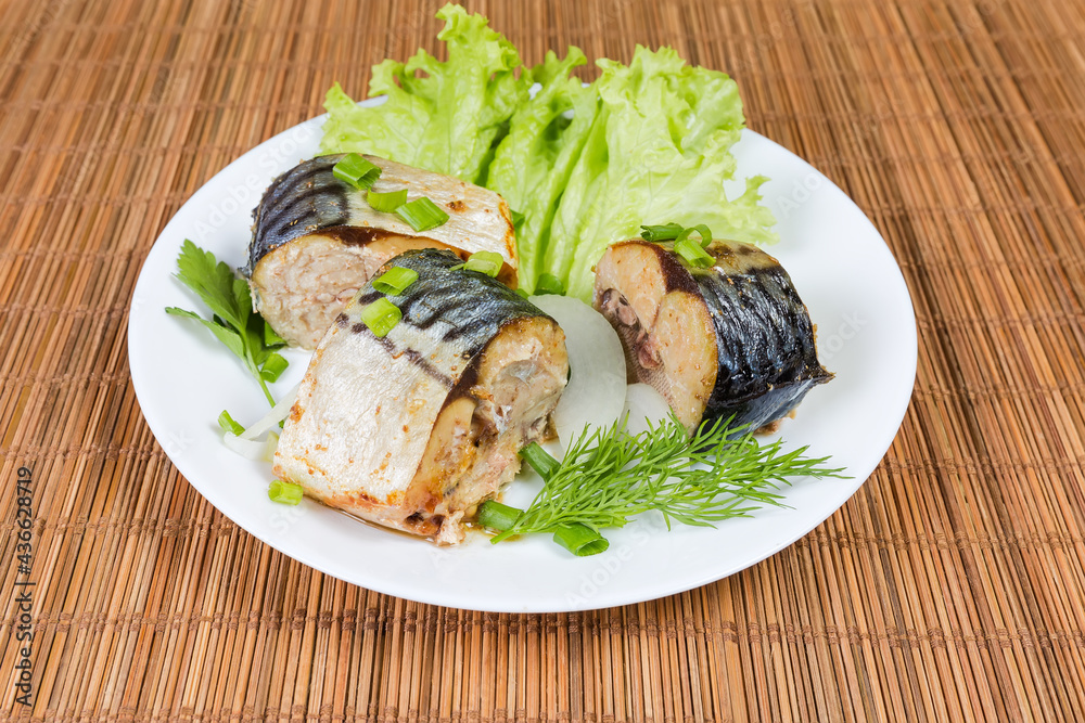 Baked slices of Atlantic mackerel with greens on dish Baked slices of Atlantic mackerel with greens on dish