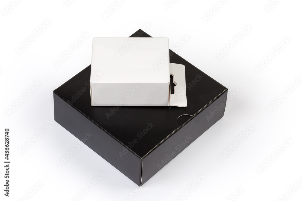 Closed white cardboard hang tab box on black packing box Closed white cardboard hang tab box on black packing box