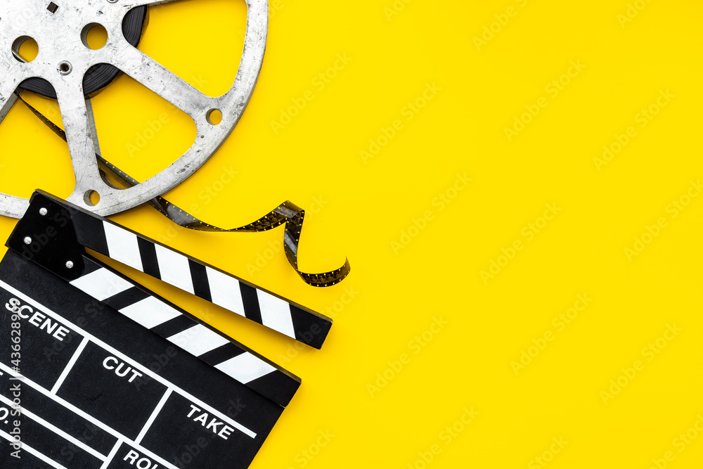 Movie film reel with clapperboard. Cinema concept