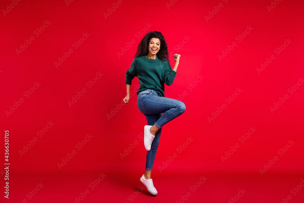 Full size photo of positive afro american young woman winner good mood isolated on red color background Full size photo of positive afro american young woman winner good mood isolated on red color background