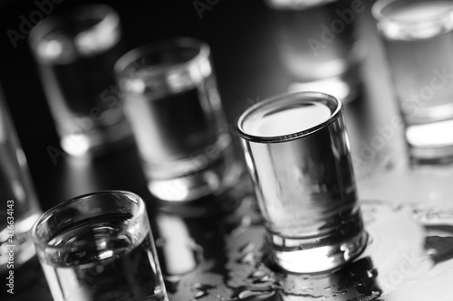 Obraz na płótnie Bottle of vodka and in a shot glass close-up.