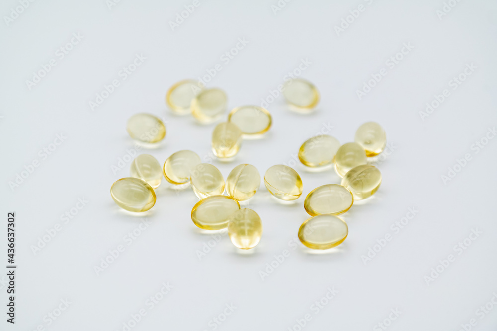 Vitamin D or Omega-3 capsule on white background. Vitamin D or Omega-3 capsule on white background.
