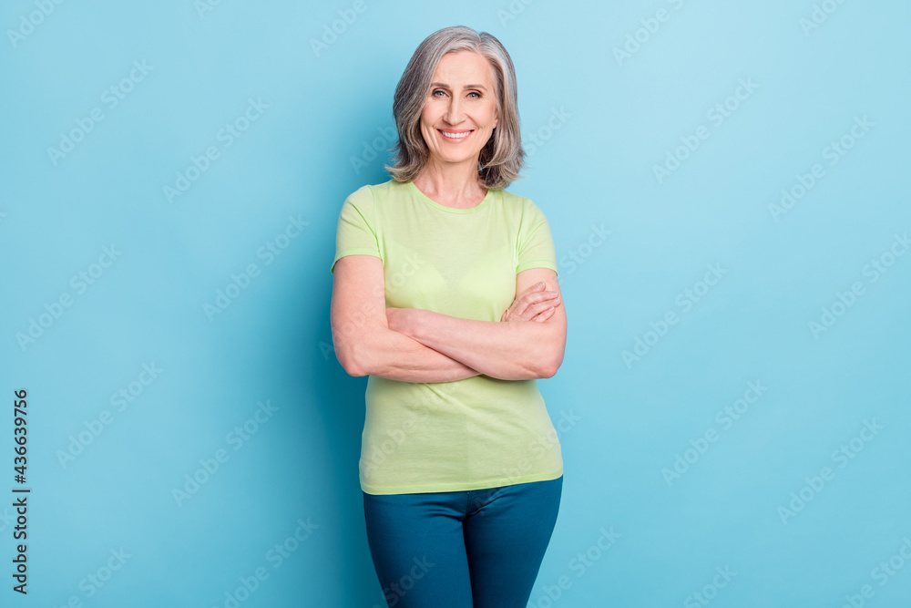 Photo of charming old attractive confident woman hold hands folded smile isolated on blue color background