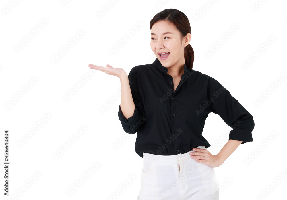 Asian cheerful business woman with hair tied wearing casual black shirt, happily smiling, presenting hand for advertisement, looking away at blank copy space with isolated white background cutout. Asian cheerful business woman with hair tied wearing casual black shirt, happily smiling, presenting hand for advertisement, looking away at blank copy space with isolated white background cutout.