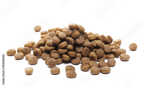 Dog food pile, dry granules for puppies and young dogs isolated on white background