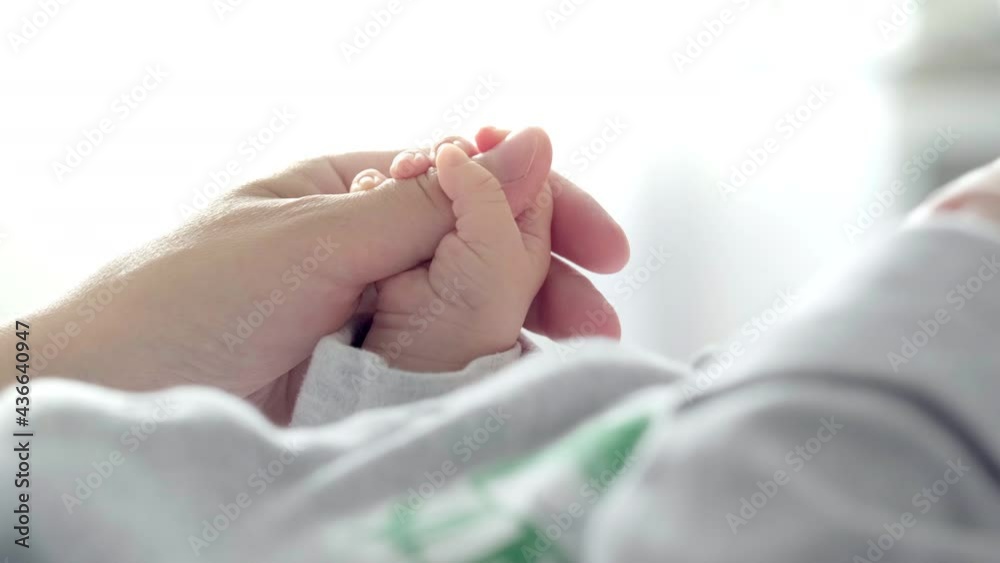 4k Newborn Baby Hand Holding Mother, Mom touching baby tiny hand to make him feeling her love, warm and secure. Maternity, family, birth concept. 4k Newborn Baby Hand Holding Mother, Mom touching baby tiny hand to make him feeling her love, warm and secure. Maternity, family, birth concept.