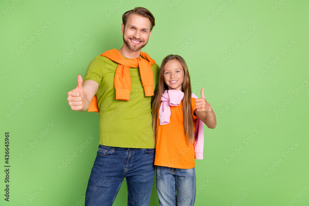 Portrait of attractive cheerful people showing thumbup yes goal success advert isolated over green color background Portrait of attractive cheerful people showing thumbup yes goal success advert isolated over green color background