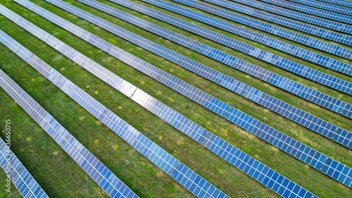 Solar power plant in the field. Aerial view of Solar Panels Farm with sunlight.