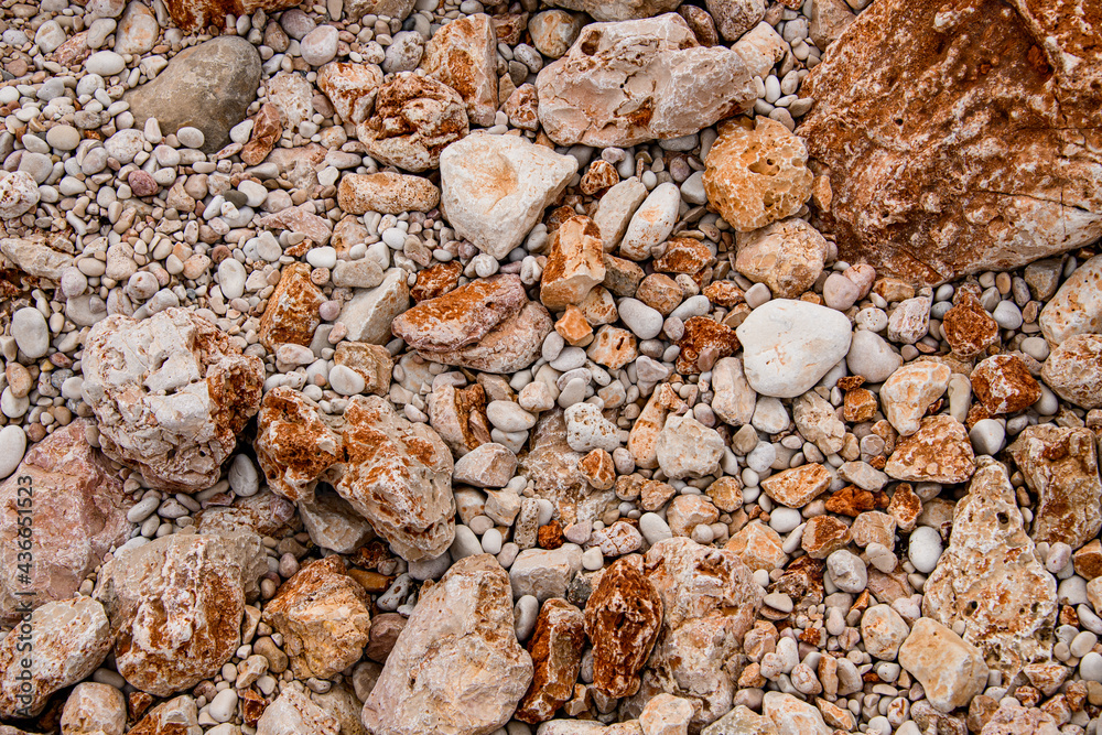 many natural colorful stones of different shapes and sizes. Rock texture. many natural colorful stones of different shapes and sizes. Rock texture.