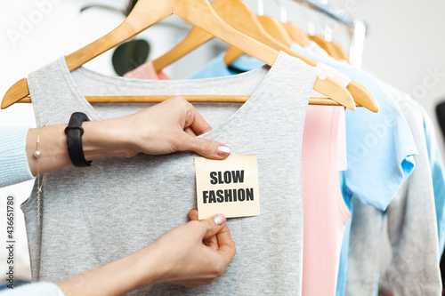 Slow fashion. Organic clothes on hangers in the store. Sustainable clothing production. photo