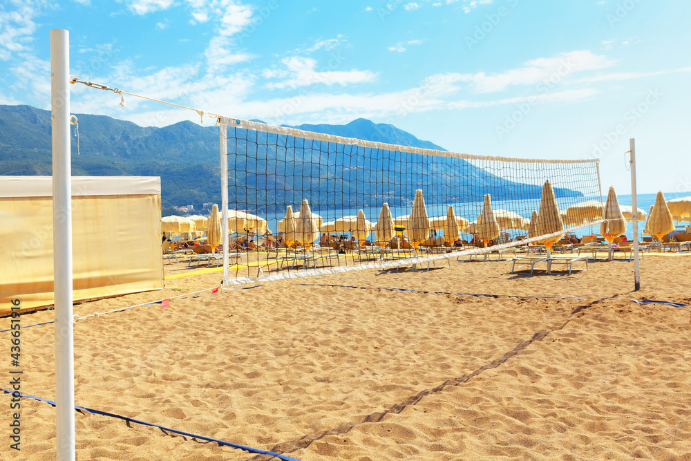 Beach volleyball playing field . Tourist resort and sandy beach in Becici Montenegro . Adriatic Sea Coast in the summertime Beach volleyball playing field . Tourist resort and sandy beach in Becici Montenegro . Adriatic Sea Coast in the summertime
