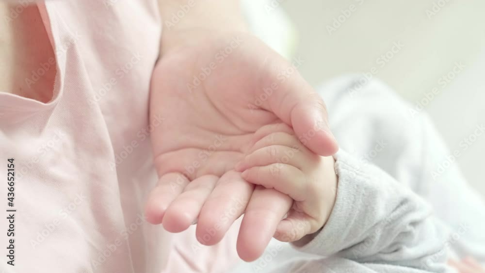 4k Newborn Baby Hand Holding Mother, Mom touching baby tiny hand to make him feeling her love, warm and secure. Maternity, family, birth concept. 4k Newborn Baby Hand Holding Mother, Mom touching baby tiny hand to make him feeling her love, warm and secure. Maternity, family, birth concept.