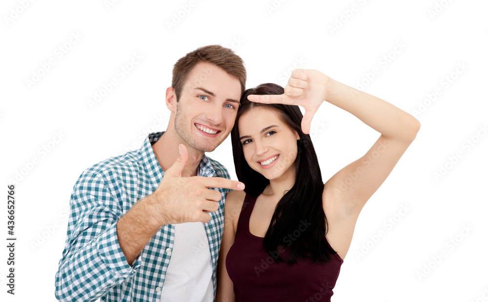 Playful couple fooling in dating day. Beautiful young lovers are joining and smiling, making frame from their hands isolated on white background Playful couple fooling in dating day. Beautiful young lovers are joining and smiling, making frame from their hands isolated on white background