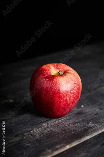 red and organic apple on a table