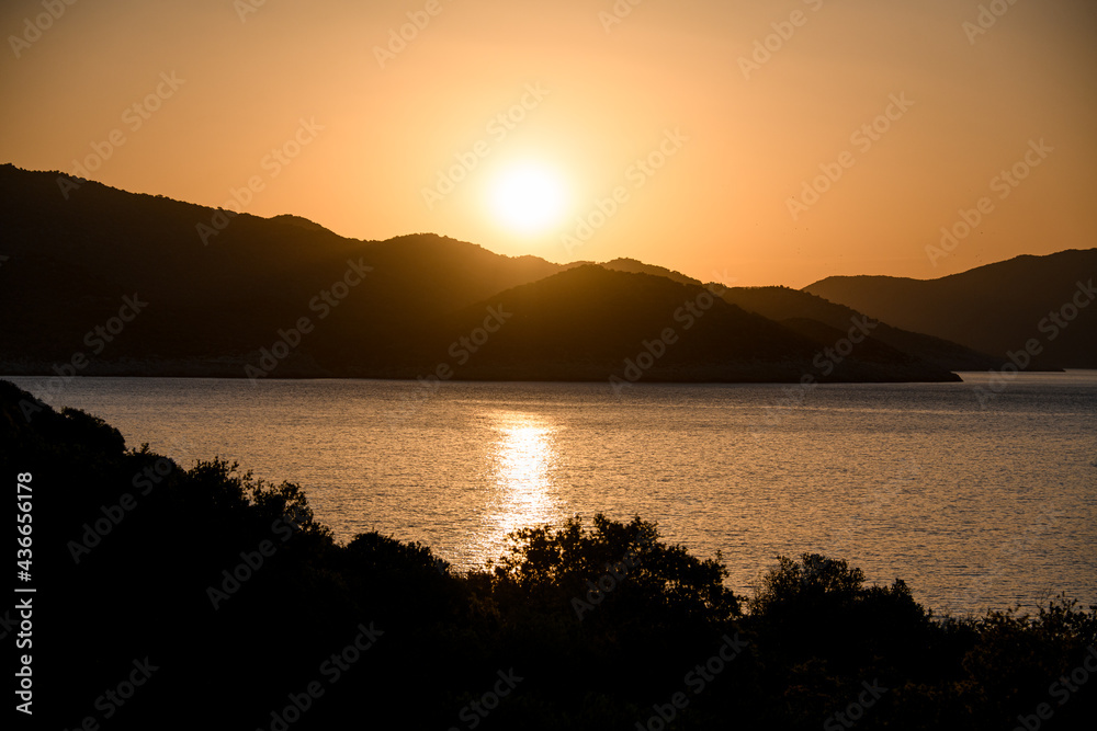 magnificent view of bright sun in the sky which is reflected in sea water.