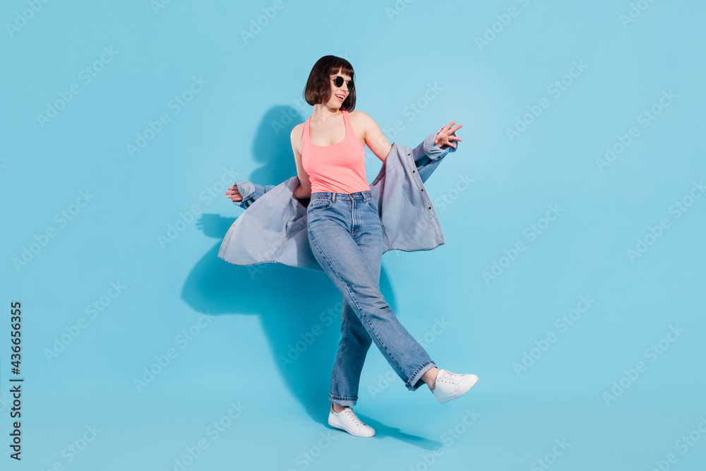 Full length body size view of attractive cheerful girl dancing moving clubbing isolated over bright blue color background