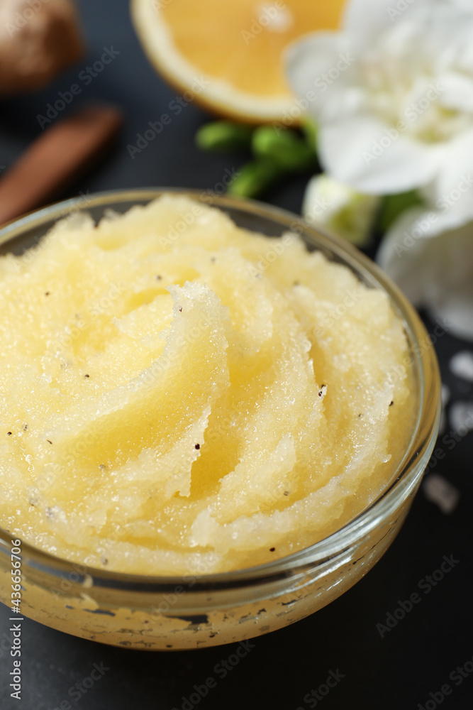 Body scrub in glass bowl on black table, closeup Body scrub in glass bowl on black table, closeup