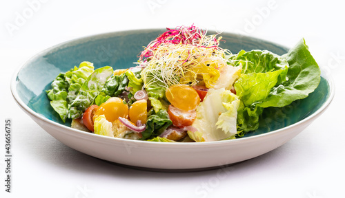 Vegetable salad in a blue plate 