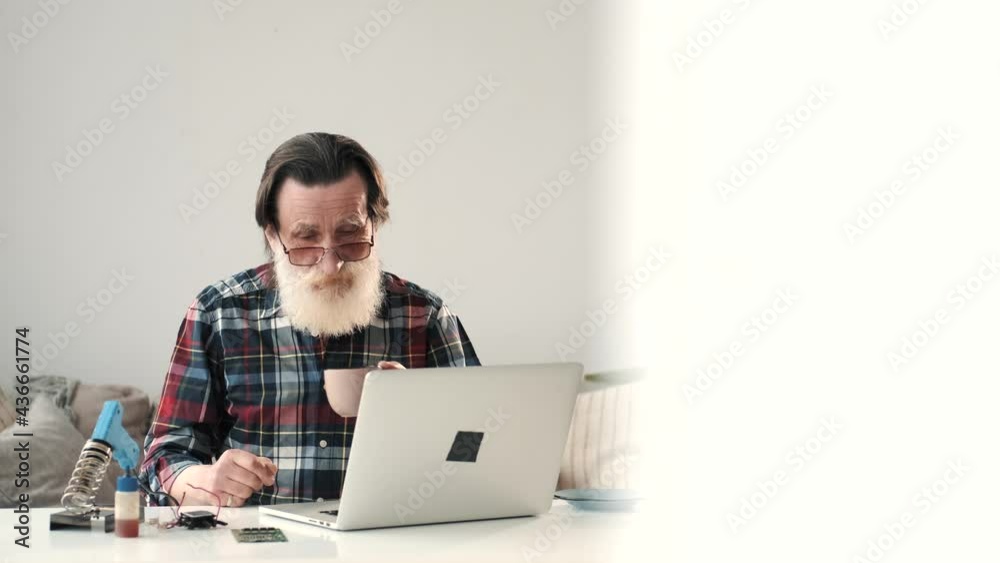 Modern senior man working on laptop at home Modern senior man working on laptop at home