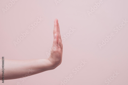 hand of a person showing stop gesture