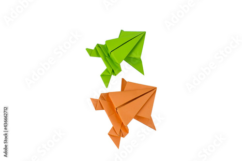 Two small hand made origami paper frog isolated on a clean paper background