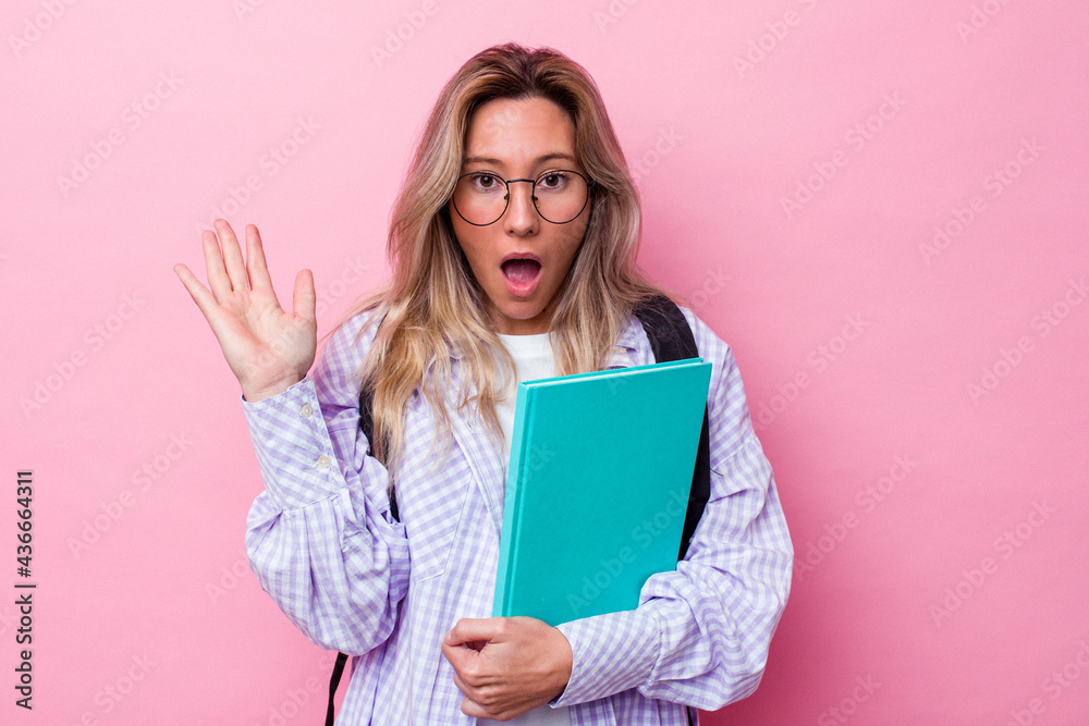 Young student australian woman isolated on pink background surprised and shocked. Young student australian woman isolated on pink background surprised and shocked.