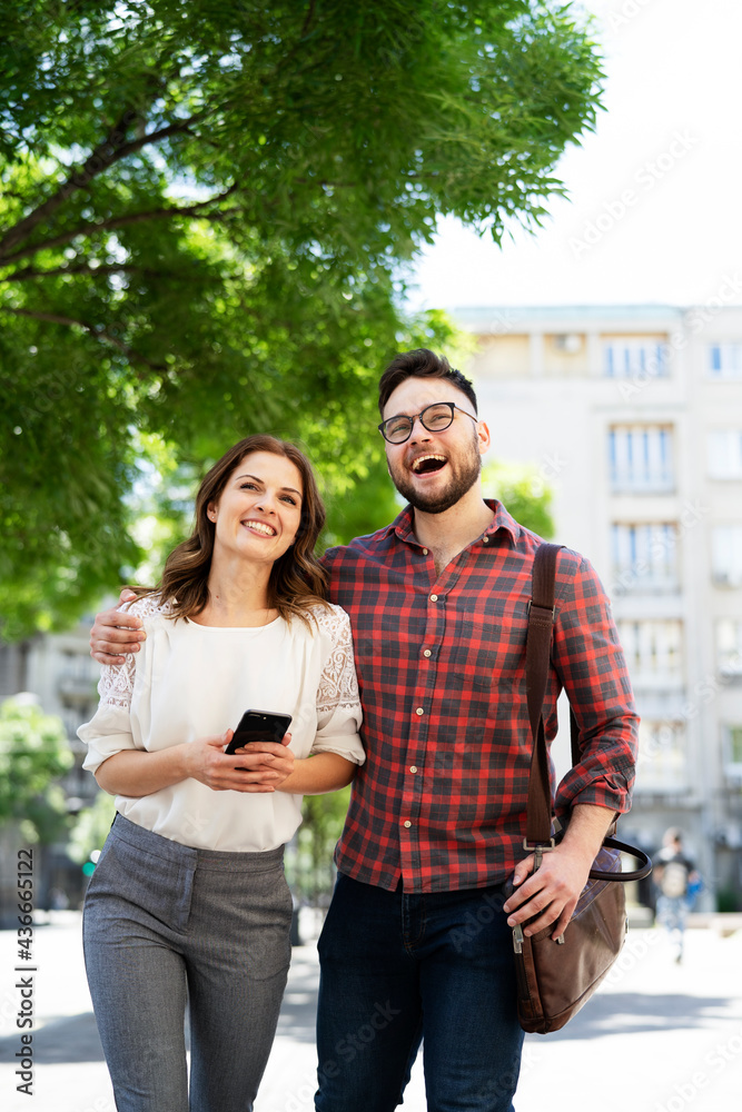 Happy young couple outdoors. Loving couple walking in the city. Happy young couple outdoors. Loving couple walking in the city.