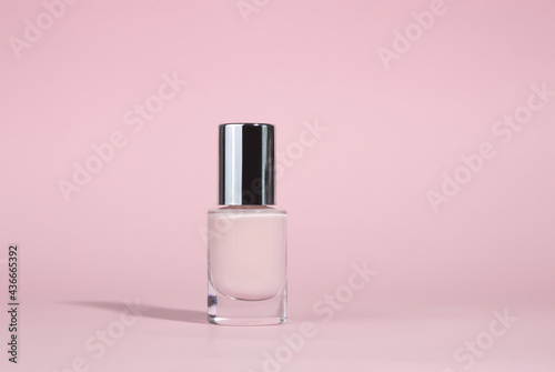 Manicure varnish or gel varnish of a beige shade isolated on a beige background. The concept of nail care and treatment and restoration of nails and cuticles. The beauty of hands.