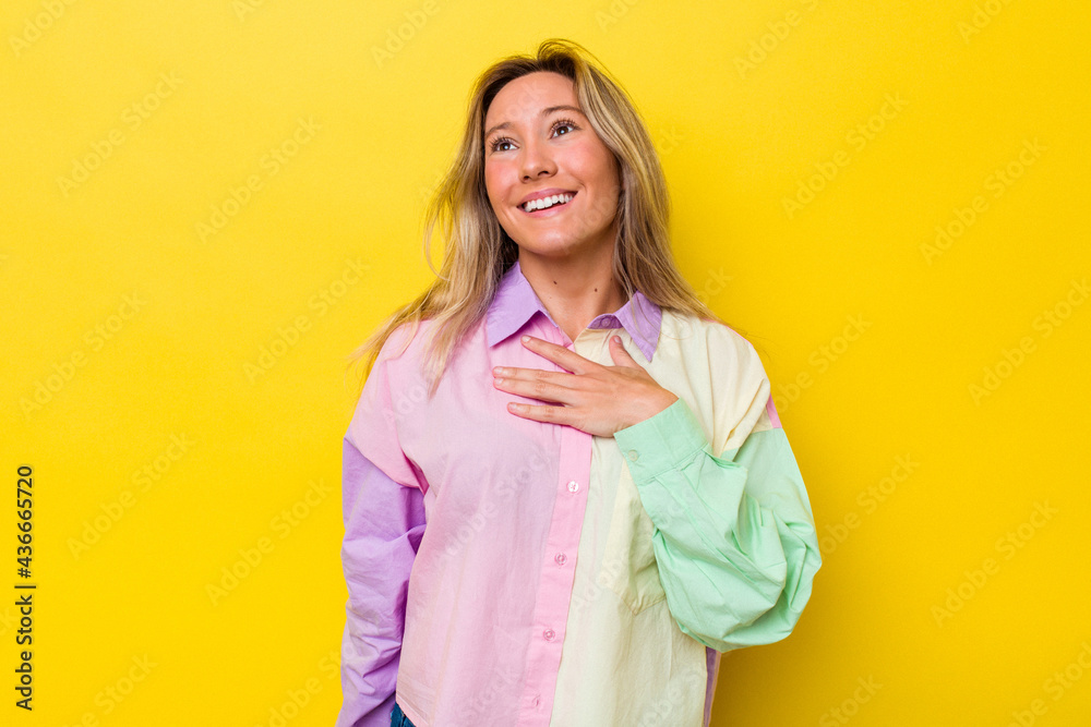 Young australian woman isolated laughs out loudly keeping hand on chest. Young australian woman isolated laughs out loudly keeping hand on chest.