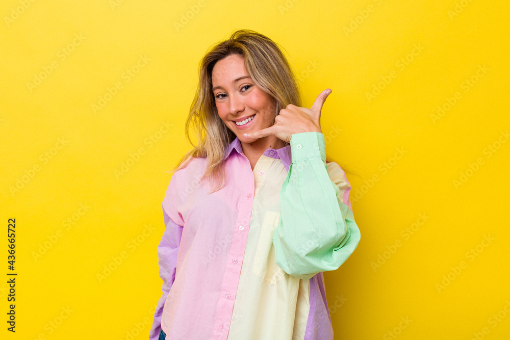 Young australian woman isolated showing a mobile phone call gesture with fingers. Young australian woman isolated showing a mobile phone call gesture with fingers.