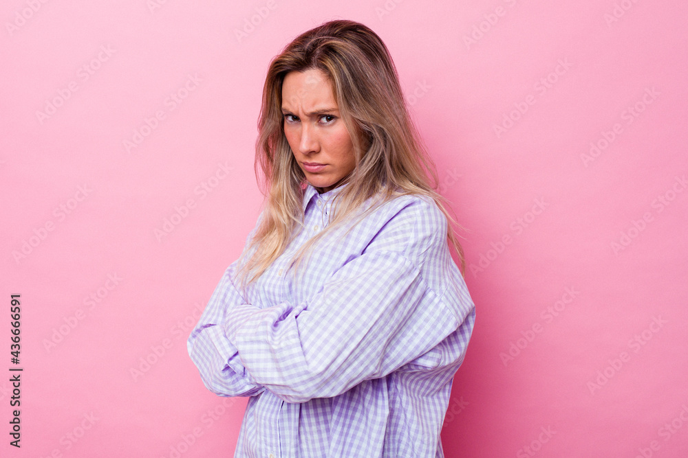 Young australian woman isolated frowning face in displeasure, keeps arms folded. Young australian woman isolated frowning face in displeasure, keeps arms folded.